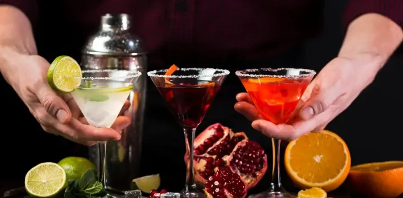 man-holding-colorful-cocktail-glasses_23-2148454465